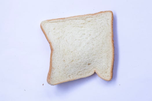 Slices of toast isolated on white background. Top view, flat photo