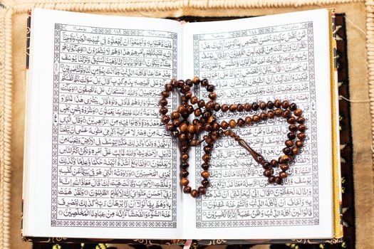 Islamic Holy Book Quran with rosary beads Ramadan concept. photo