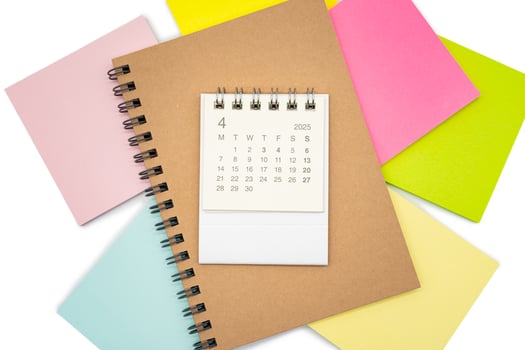 Simple desk calendar for APRIL 2025 with office supplies. Calendar concept with copy space. 2025 APR calendar. photo