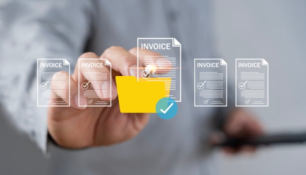 E-invoice and online digital statements concept. Businessman using computer laptop with invoice icons on virtual screen. photo