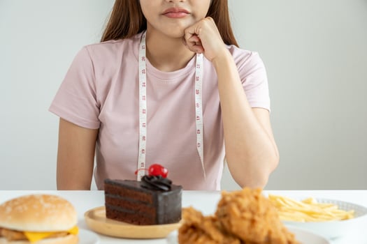 slim body asian women very bored diet food, dieting female choose low calories food for diet. Good healthy food. weight lose, balance, control, reduce fat, routines, exercise, body shape photo