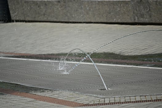 a man is playing with a water fountain photo