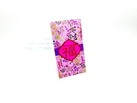 A vibrant red envelope or angpao or angpau or red packet used for gifting money during celebrations with gold floral patterns and a Chinese character for good fortune or prosperity photo
