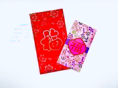 A vibrant red envelope or angpao or angpau or red packet used for gifting money during celebrations with gold floral patterns and a Chinese character for good fortune or prosperity photo