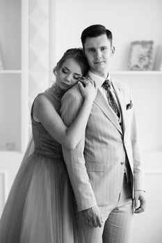 groom in beige suit and bride in lavender wedding tight dress photo