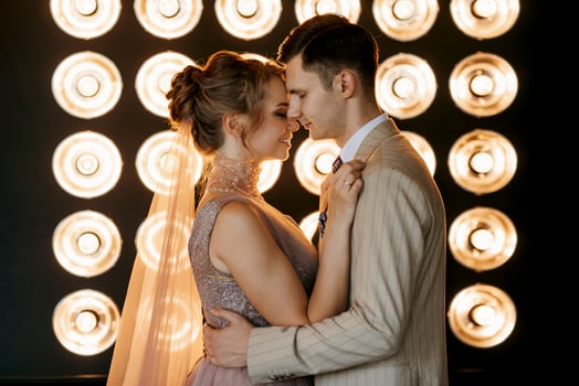 groom in beige suit and bride in lavender wedding tight dress photo