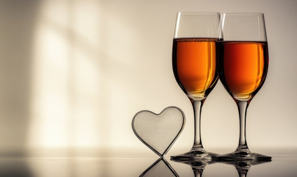 Two wine glasses with a heart in between them photo