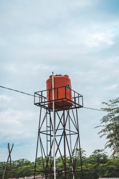 A water tower with a red roof photo