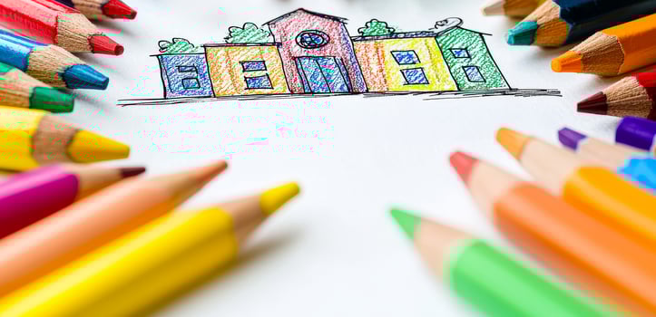 Colorful drawing of a house surrounded by crayons. A vibrant house drawing is surrounded by a variety of colored pencils, showcasing creativity and art. photo