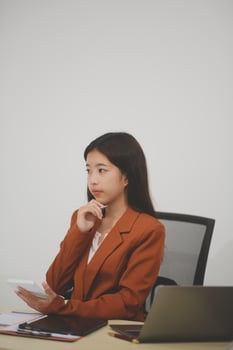 A driven and dedicated young professional showcases her efficiency and attention to detail as she works diligently on her laptop photo