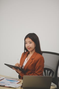 A driven and dedicated young professional showcases her efficiency and attention to detail as she works diligently on her laptop photo