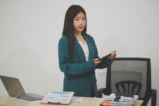 Business, finance and employment, female successful entrepreneurs concept. Friendly smiling office manager greeting new coworker. Businesswoman welcome clients with hand wave, hold laptop photo