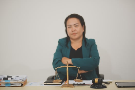 Pretty Asian female lawyer working and hammer, laptop, justice advice and legal concept. In office photo