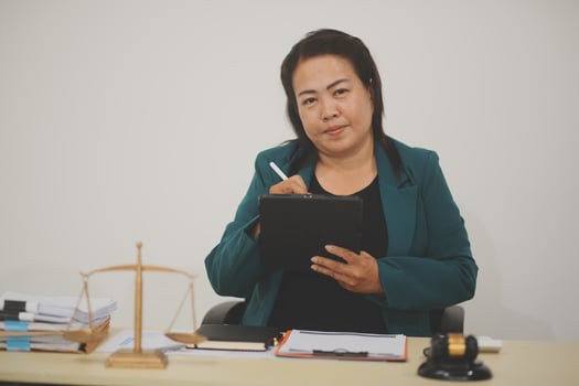 Pretty Asian female lawyer working and hammer, laptop, justice advice and legal concept. In office photo