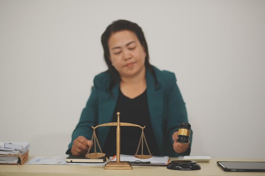 Pretty Asian female lawyer working and hammer, laptop, justice advice and legal concept. In office photo