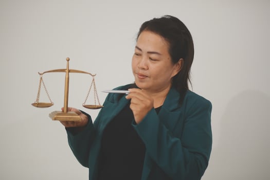 Pretty Asian female lawyer working and hammer, laptop, justice advice and legal concept. In office photo