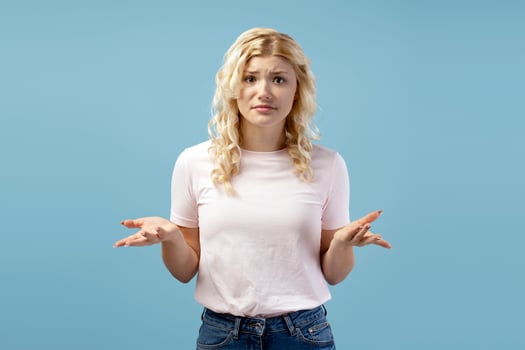 Portrait of sad, perplexed teenager, girl wearing casual clothes choosing, looking at camera photo