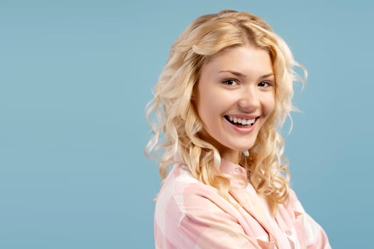 Closeup, smiling happy, smiling teenager looking at camera, posing isolated on blue background photo