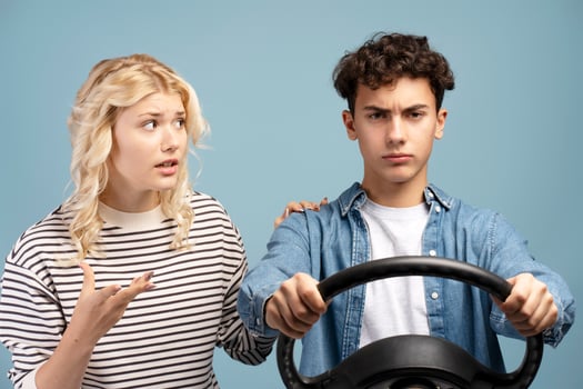 Upset teen couple, angry boyfriend and girlfriend having conflict, boy holding steering wheel photo