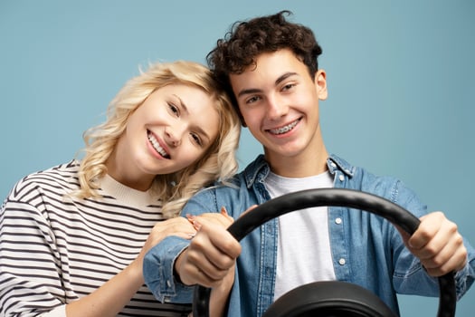 Happy, attractive couple, boyfriend and girlfriend holding helm together looking at camera photo