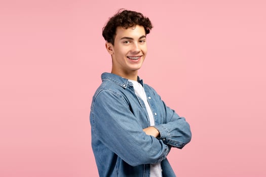 Smiling, handsome, happy teen boy, wearing casual clothes, looking at camera with crossed arms photo