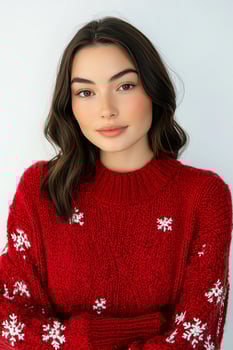 A woman wearing a red sweater with snowflakes on it photo