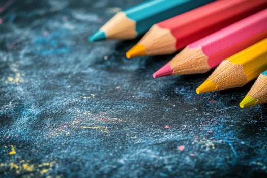 Colorful pencils arranged neatly on a dark surface for creative projects and art activities photo