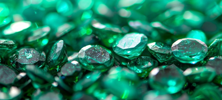 A close-up view of sparkling Emeralds with intricate facets reflecting light. Brilliance and rich green tones of gemstones. Concept of luxury, jewelry, diamonds, elegances. Background. Copy space photo