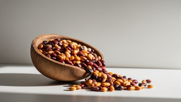 A wooden bowl filled with beans and nuts photo