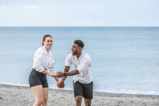 A couple enjoys some lighthearted moments at Zapillo Beach in Almeria, Spain, as they have a playful interaction on the serene beach. photo