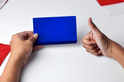 Hands holding and showing a blue savings account book with an okay gesture photo