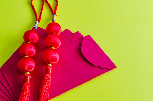 Chinese New Year lanterns on top of red packets on yellow cover background. Chinese New Year celebration photo