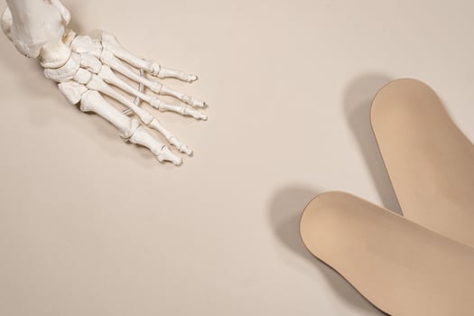 Orthopedic insoles for shoes on a colour background. Foot care photo