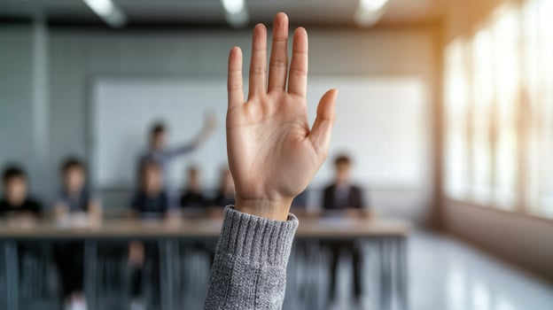 hand raised in classroom setting photo