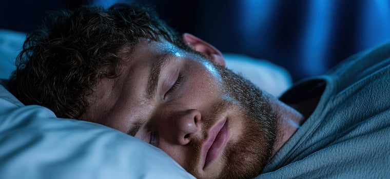 man sleeping peacefully in bed photo
