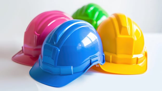Four Colorful Hard Hats on a White Surface photo
