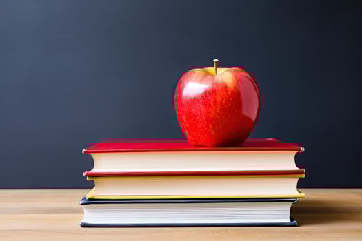 Red apple on stack of books photo