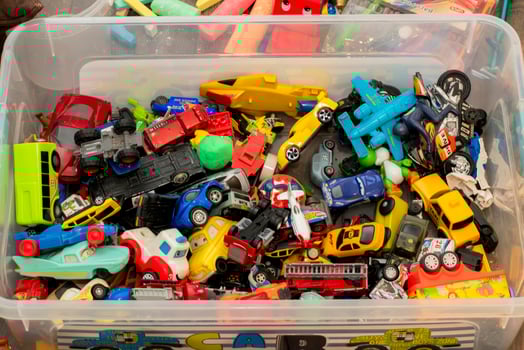 Colorful collection of toy cars and vehicles in a storage container photo