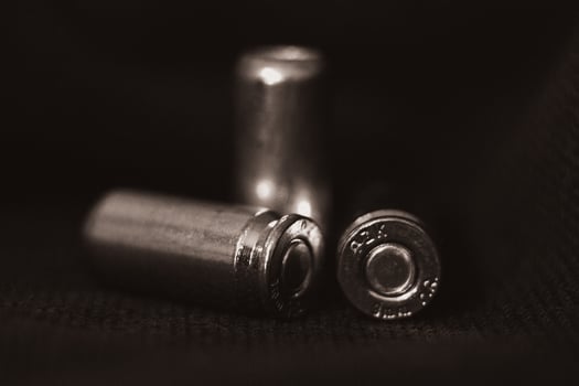 View of three pistol bullets in black and white photo