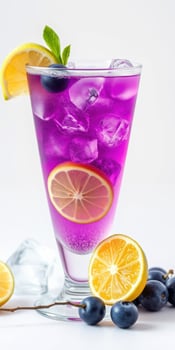 Refreshing purple drink with lemon slices and blueberries served in a tall glass on a clean surface photo