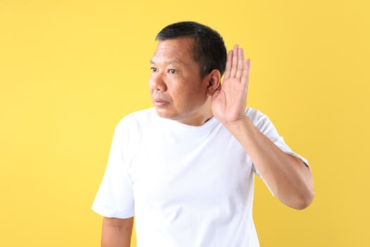 Asian Middle Age Man with Hand on His Ear, Having Bad News or Lack of Hearing Concept photo