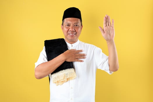 Middle Age Asian Male Wearing Baju Koko Going to Mosque fro Sholat Jumat Friday Prayer photo
