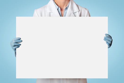 Health, medicine and quarantine. Adult woman doctor in protective mask, white coat and rubber gloves holding poster with free space, isolated on gray background, free space, studio shot, cut out photo