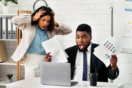 Stressed African American coworkers missing project deadline at office photo