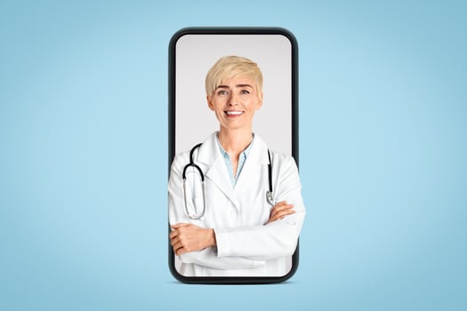 Modern medicine and private practice. Cheerful adult woman doctor in white coat and stethoscope, crossed her arms and waiting for patient, isolated on gray background, studio shot, cut out, free space photo