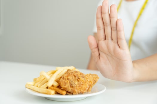 Beauty slim female body confuse French fries. Woman in restaurant achieves weight loss goal for healthy life, crazy about thinness, thin waist, nutritionist. Diet, body shape. photo