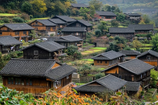 Hillside village with traditional wooden houses and dark tiled roofs. photo