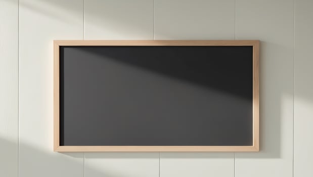 blank chalkboard with wooden frame on clean wall photo