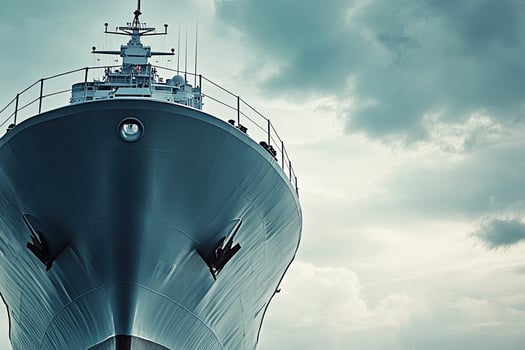 A close-up view of a ship's bow against cloudy skies. photo