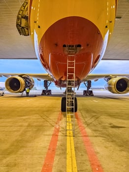 Close-Up View of Airplane Underbelly and Landing Gear on Tarmac. High quality photo